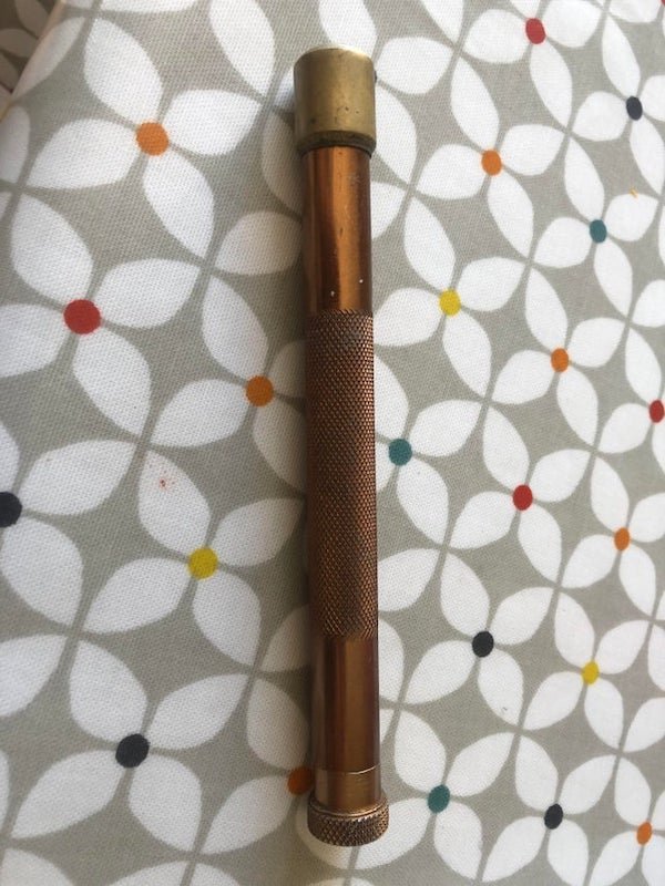 Brass tube, all parts screw together. Has a scoop and a weighted end.

A: Fly fishing priest. Weighted end for dispatching fish and Scoop is for checking stomach contents.