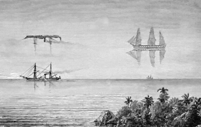 Practically since sailing was first invented, sailors have reported seeing mysterious floating objects on the horizon. The most famous of these is the "Flying Dutchman," sightings of which likely originated in the 1600s - but persisted into the 20th century. Usually, these sightings had similar details: A ghostly ship appears just over the horizon, appearing to be lit by some kind of unearthly light, usually during a storm. Sailors theorized that this ghost ship was a former Dutch trading vessel doomed to sail the ocean for eternity, and whenever it appeared before living sailors, it was a bad omen. Poems about ghost ships helped spread these legends even further, like Walter Scott's Rokeby or Samuel Taylor Coleridge's The Rime of the Ancient Mariner.

Ghost ships are just one type of unearthly object people have spotted at sea. In 1643, the Jesuit priest Domenico Giardina reported seeing a floating city over the strait of Messina, just over the horizon. In 1810, cartographers Yakov Sannikov and Matvei Gedenschtrom reported seeing a floating land mass among the New Siberian Islands.

In reality, reports of ghost ships, ghost cities, and ghost islands are all examples of a common optical illusion called "Fata Morgana." (The name derives from the character Morgan le Fay, a sorceress from the legend of King Arthur who could create beguiling illusions.) A Fata Morgana is caused by the way our eye perceives light when it passes through spaces with different densities. At the ocean's surface, the water keeps the air relatively cool. Above that layer of cool air is another layer of warmer air. These differences in temperature create atmospheric layers with different densities. When light passes through them, it refracts, or bends. The human eye assumes the light it can see travels in a straight line, so from a distance, refraction can make an object on the water's surface appear as if it's floating above it. Most likely, superstitious sailors probably were seeing real ships. They just looked like they were floating in the air.

Fata Morganas are convincing enough that even though we now know their cause, we can still fall for them. In 2015, residents of Foshan and Jiangxi reported seeing a floating city in the sky. Once again, it was just a mirage.
