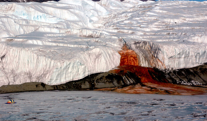 In 1911, explorer and geographer Thomas Griffith Taylor stumbled upon a bizarre sight at the edge Taylor Glacier in East Antarctica. Taylor noted the occurrence of red blood-colored water flowing out of the glacier. At first, scientists thought it was some sort of algae that gave the water the reddish color. They eventually realized iron oxides were the reason, but how this occurred remained a mystery for over 100 years. In 2017, scientists finally discovered the source. Using radio-echo sounding radar, they were able to uncover that the waterfall was connected to an iron-rich source of water trapped under the glacier. The briny water source is believed to be over a million years old -- making Blood Falls one very strange and very old waterfall.