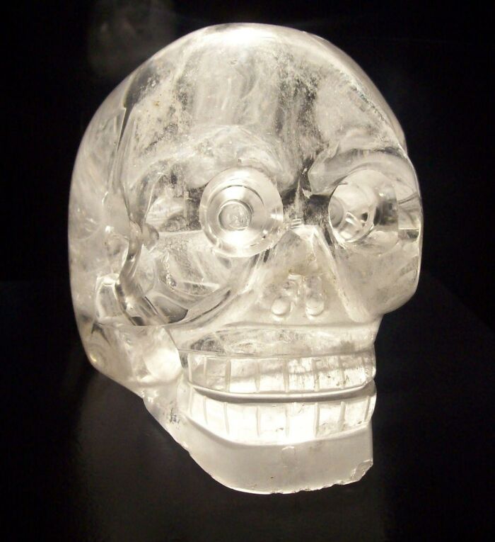 People have been fascinated with crystal skulls long before 2008's Indiana Jones and the Kingdom of the Crystal Skull. These hunks of quartz carved into the shape of a human skull supposedly originate from pre-Columbian Mesoamerican civilizations like the Aztecs, the Mayans, the Toltecs, and the Olmecs. They first attracted worldwide attention in the late 19th century when a French antiquarian operating in Mexico City, Eugène Boban, claimed to have discovered authentic Aztec crystal skulls and sold them to a private collector. Crystal skulls soon became a sought-after collector's item, and not just because they were curiosities. Some believed the skulls had healing properties or gave their owners psychic abilities. Others believed they were related to the lost city of Atlantis, and still others believed they were of extraterrestrial origin.

Crystal skulls have remained in museums like the British Museum, so modern archaeologists have been able to examine them and determine where they come from. The verdict? All evidence points to crystal skulls being fakes. For starters, no crystal skull has ever been found in situ at an authentic Mesoamerican archaeological site, meaning there's no way to prove they actually are of ancient origin. By using electron microscopes, archaeologists determined that the techniques used to make the skulls could only have been made with 19th century metal equipment, and not the stone, wooden, or bone tools Mesoamerican civilizations had access to. Most of all, the quartz used to create the skulls comes from either Brazil or Madagascar, neither of which are home to any of those four Mesoamerican civilizations. In the late 19th century, Europeans and Americans were becoming more interested in Mesoamerican cultures, and it's likely the skulls were created to capitalize on this trend.