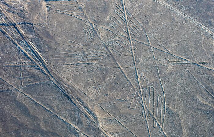 Discovered in the 1930s (when we could finally fly high enough), the Nazca Lines are massive white geoglyphs – some being 275m across – made from shallow lines dug into the ground. The whole area is about 190 square miles (500km²). They are thought to have religious significance to the Nazca culture.

Given that aeroplanes are thought to have been in short supply between 500 B.C.E. and 500 C.E., how could the Nazca people see what they were doing?

Author Jim Woodman thought it could have been done by using a basic hot air balloon and shouting directions to the diggers below. To test the theory, Woodman made a functioning balloon with materials they would have had back then. The only problem is there is no proof the Nazca people even knew what a balloon was. Popped that theory.

However, wooden stakes at the site, carbon-dated to the Nazca period, have given researchers a hunch that people at the time may have drawn long ropes between stakes to make the lines. So Dr Joe Nickell and three assistants – including an 11-year-old – used the method to make a giant bird. And it only took them a few hours.

Mystery solved.