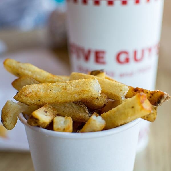why Five Guys gives extra fries at the bottom of the bag. They do it so the guests think they are getting a good deal. However, the extra fries are already factored into the menu price. Founder Jerry Murrell also says it is better for customers to feel that their serving of fries was too large.”