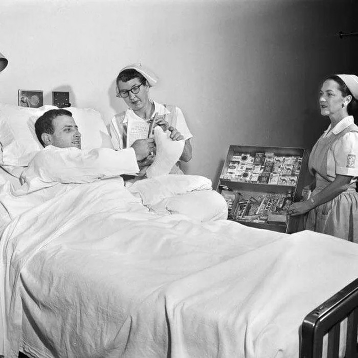 A man buying cigarettes from his hospital bed, 1950s