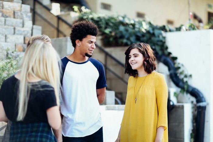 Standing there while two people talk about something you don't know about.