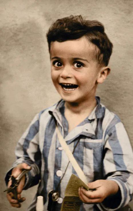 Istvan Reiner, aged 4, smiles for a studio portrait, shortly before being murdered at Auschwitz concentration camp.