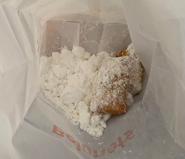 I got a couple of beignets in this bag of powdered sugar from Popeye’s.