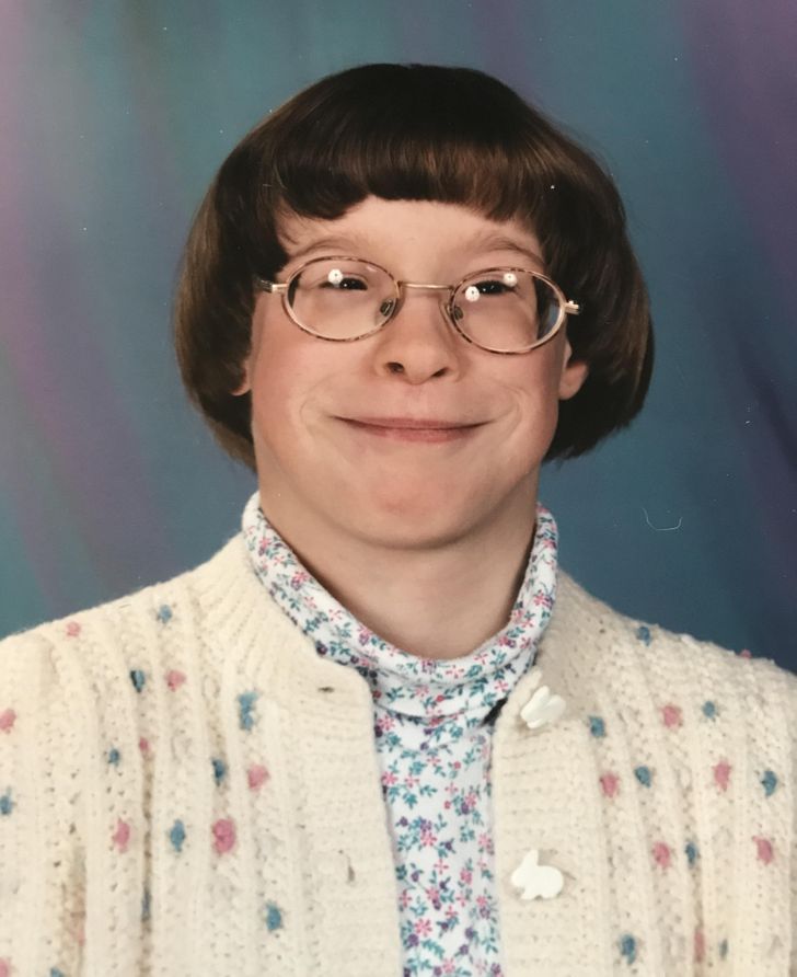 “School photo looking like a 60-year-old librarian with my cardigan, turtleneck, and thick glasses, date and age unknown.”