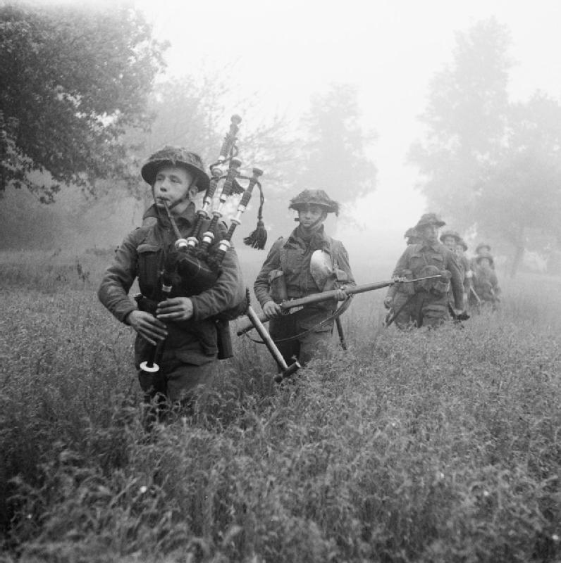 Led by their bagpiper, men of the 7th Battalion, Seaforth Highlanders, 46th (Highland) Brigade, advance during the First Battle of the Odon; June 26, 1944. The Odon river is in Normandy, France and the battle was part of the British offensive to take the city of Caen, which was captured on July 9, 1944.