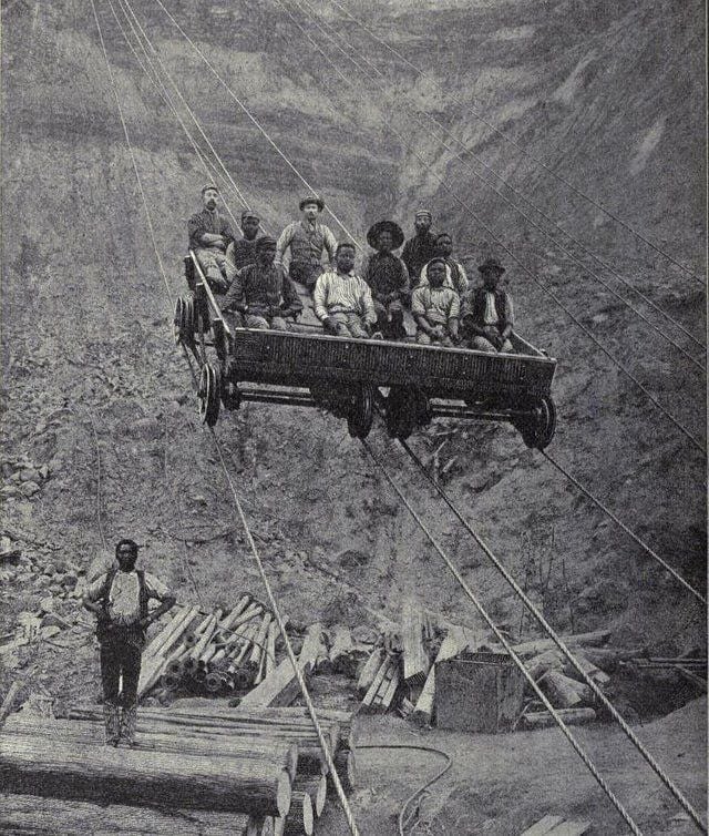 Miners on an aerial tram used to descend into the Kimberley Diamond mines in South Africa, ca 1885.