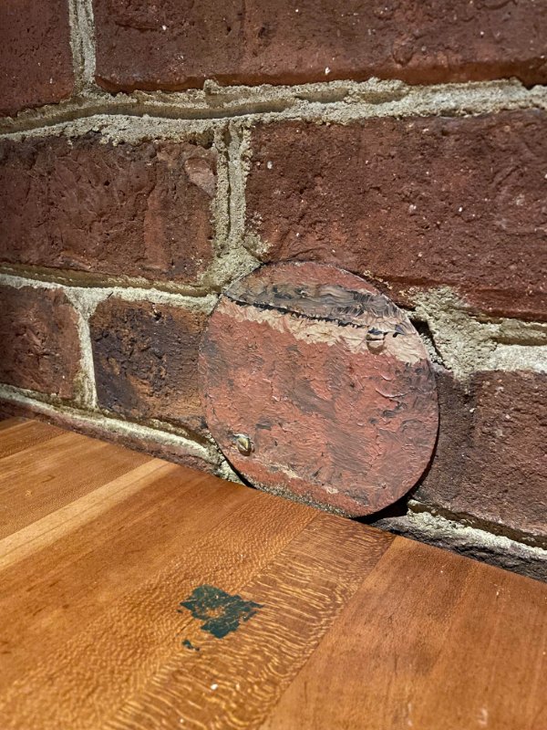 This cover painted to look like brick at a restaurant.