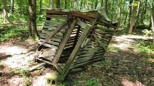 Small wooden building found deep in the woods on state land with nothing around it. Above the door it says it belongs to a local trap and field club (about two miles down the road.)

A: It’s most likely an old blind for hunting