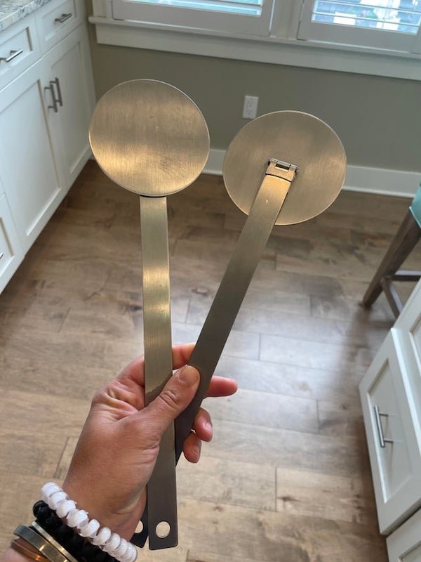 Two flat metal round disks with long stem attached by hinges. No markings. Found in a new kitchen.

A: It’s a flame snuffer