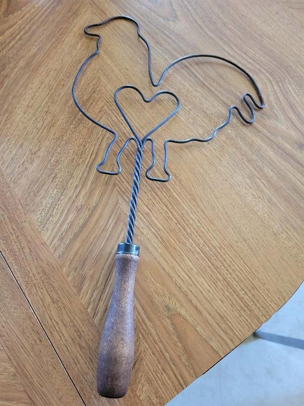 Chickenheart wire object with handle

A: Modern decoration made in the style of an old Rug Beater.