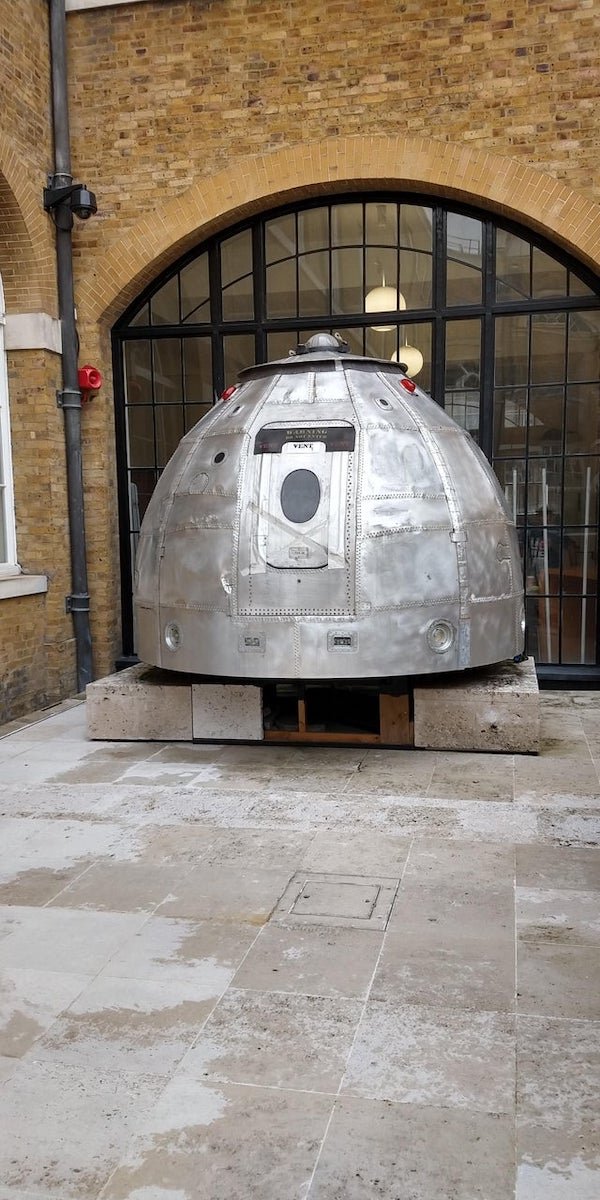 Domed metal object, 3-4 metres tall, seen on a university campus in London, text reads “WARNING DO NOT ENTER – VENT VENT VENT”

A: It’s art. Titled “Dissent Module” by Rachel Ara.