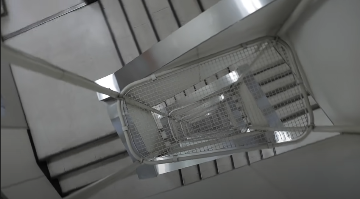 This building’s staircase has anti-suicide nets between each floor