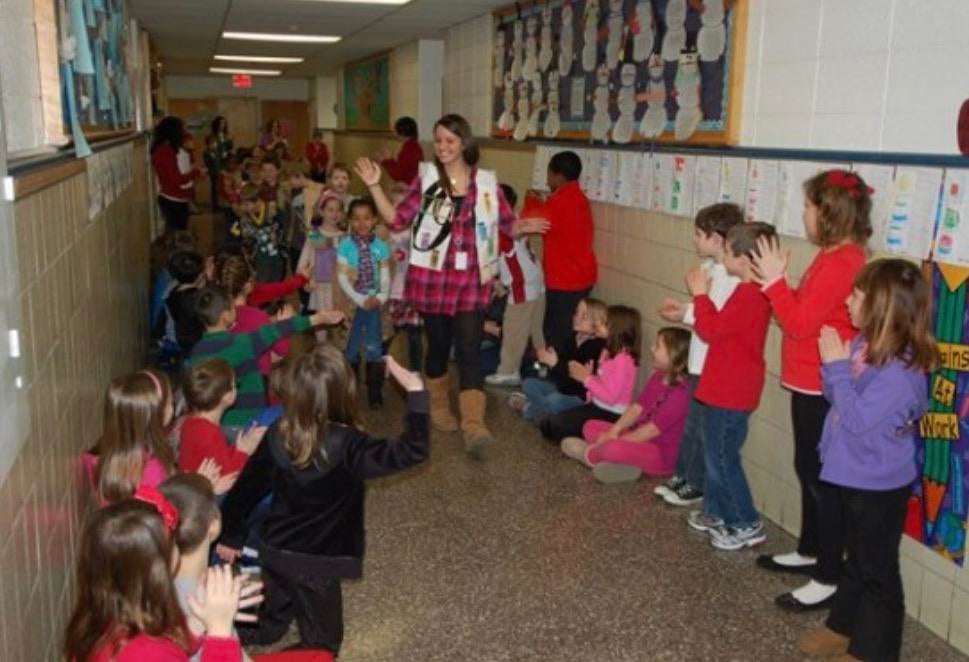 First grade teacher Victoria Soto leads her students in a Christmas parade. Less than 2 weeks later Soto and 5 of her students (alongside 21 other people) would be murdered by Adam Lanza during the Sandy Hook Elementary School shooting