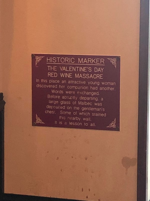 “A plaque commemorating this wine stain on the wall of a local restaurant.”