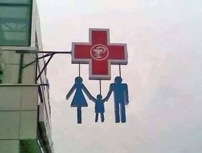 family hanging from pharmacy sign