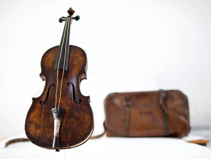 This is the Hartley Violin, owned by Wallace Hartley, the bandmaster and lead violinist on the Titanic. It was the one he carried with him and played on the night the ship sank. Survivors reported seeing Hartley and his band on the deck of the ship during the sinking, playing to calm passengers as they boarded the insufficient lifeboats. Hartley and every member of the band died in the sinking. We have his violin because at some unknown point before his death, Hartley tucked the violin back into its monogrammed case for safekeeping. That's how it was found, floating in the debris field, by one of the ships sent to recover bodies from the wreck. They were able to identify it as Hartley's because of an engraved brass plate, and it was returned to his fiancé, who kept it until her death. Her family authenticated it and sold it for $1.6M to an organization that collects Titanic artifacts."