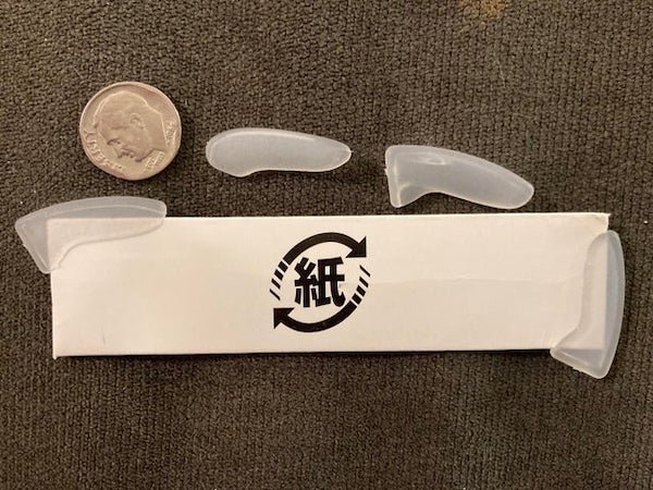 What are these small plastic things with a tiny slot that came in individual, different sized envelopes?

A: We did get a knife set as a gift, and I was able to quickly match the envelopes and plastic to different knives.