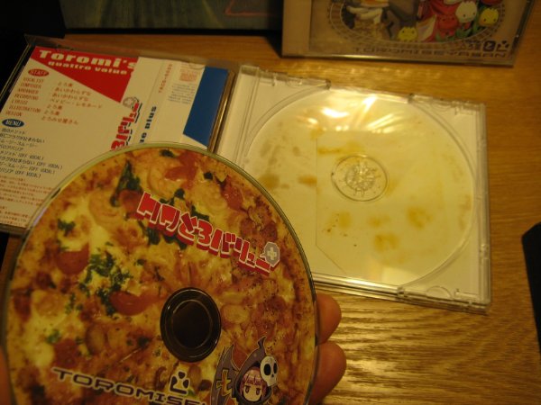 “This music CD has fake pizza stains on the case to go along with it’s pizza theme.”