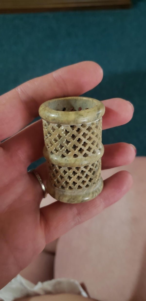 About 2″ tall hand carved marble cup. Is at least 110 years old. I was told these were found on the desks of wealthy men. What is it?

A: It’s an Indian incense burner, made of soap stone.