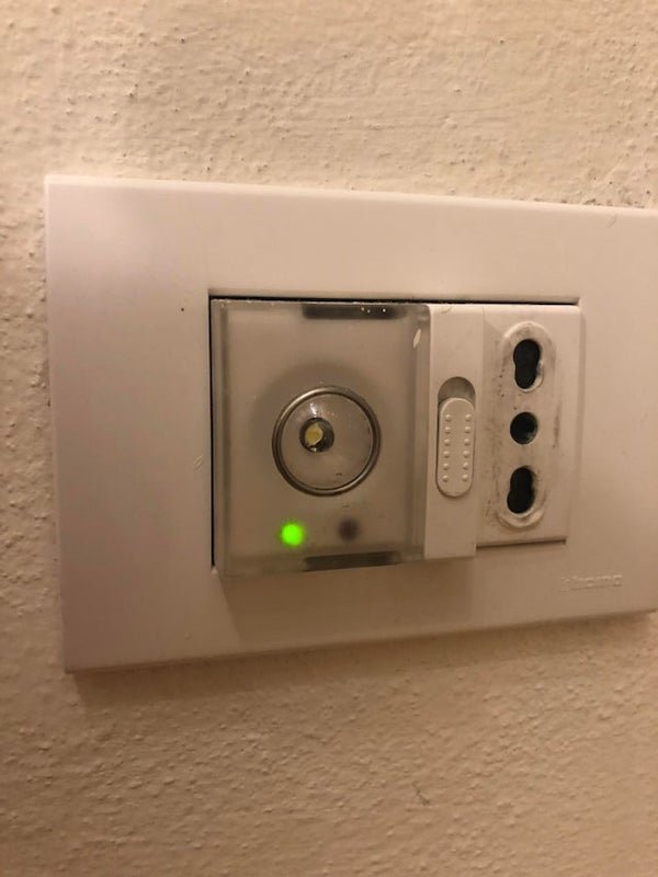 Saw this transparent plastic thing while staying in an airbnb in Italy. It was firmly put in this electrical socket which is at about ankle height. It made no sound, it had the green light on all the time and the plastic thing seems to be a removable lid, but I did not try to force it open.

A: It’s an emergency light