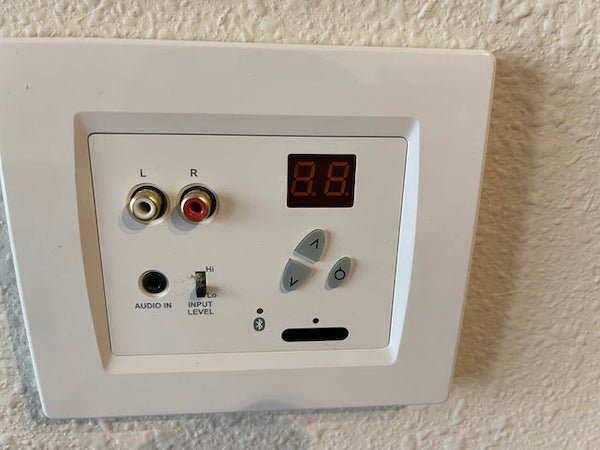 Panel in apartment (USA) appears to be audio visual related but don’t know what the up down and power (?) is for.

A: It’s an input with volume control for a speaker installed in the house.