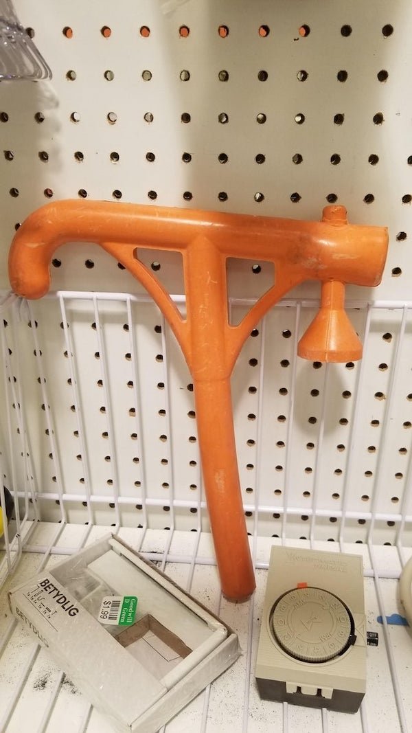 What is this flaccid orange hammer?

A: It’s a baseball tee for training hitters that tend to drop their swing. The little cup thing is installed upside down, but would be used to hold the ball.