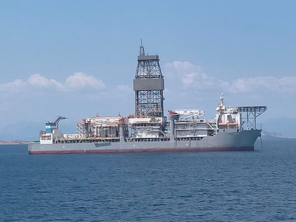 What is this unusual-looking ship with large on-board tower? Sighted anchored less than a mile off-shore of Piraeus, Athens, Greece.

A: Looks like a drillship. You can check marine traffic here to try and get the vessel name.