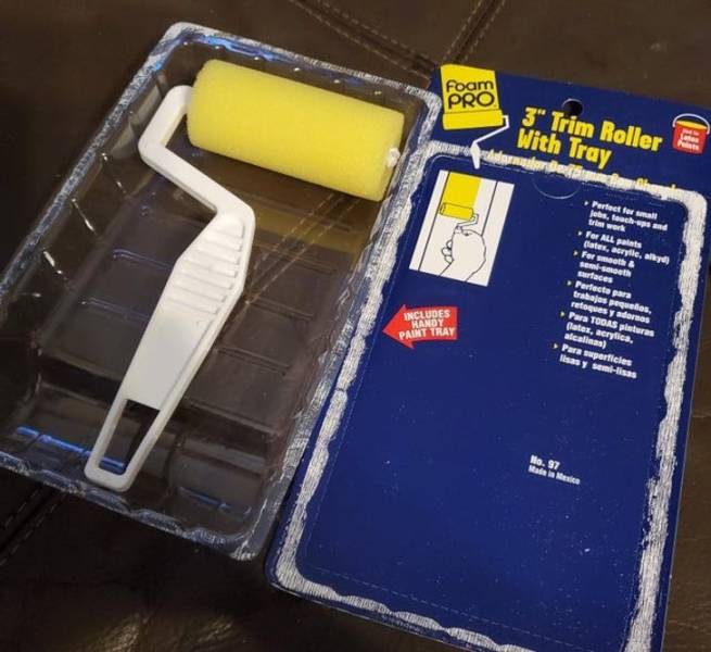 "The plastic packaging for this paint roller is a paint tray."