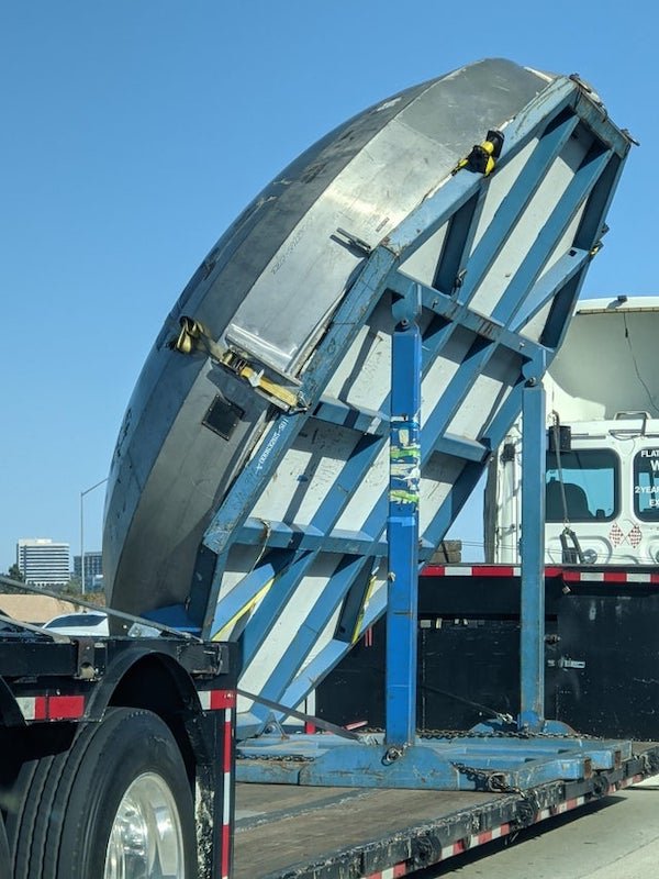 What is this giant metal disc being transported by truck?

A: The top of a silo