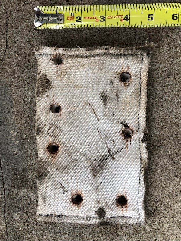 What is this white 5” x 8” rectangular pad with 7 irregularly spaced holes?

A: It’s heat insulation for parts of the engine.