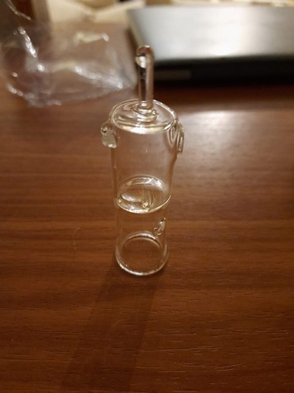 Glass tube with chambers holes and an elongated nipple found in a home.

A: Oil defuser attachment for a dry herb vape