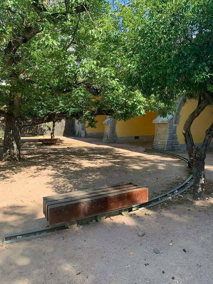 This park bench has rails underneath it so you can move it to different spots as the shade moves during the day.