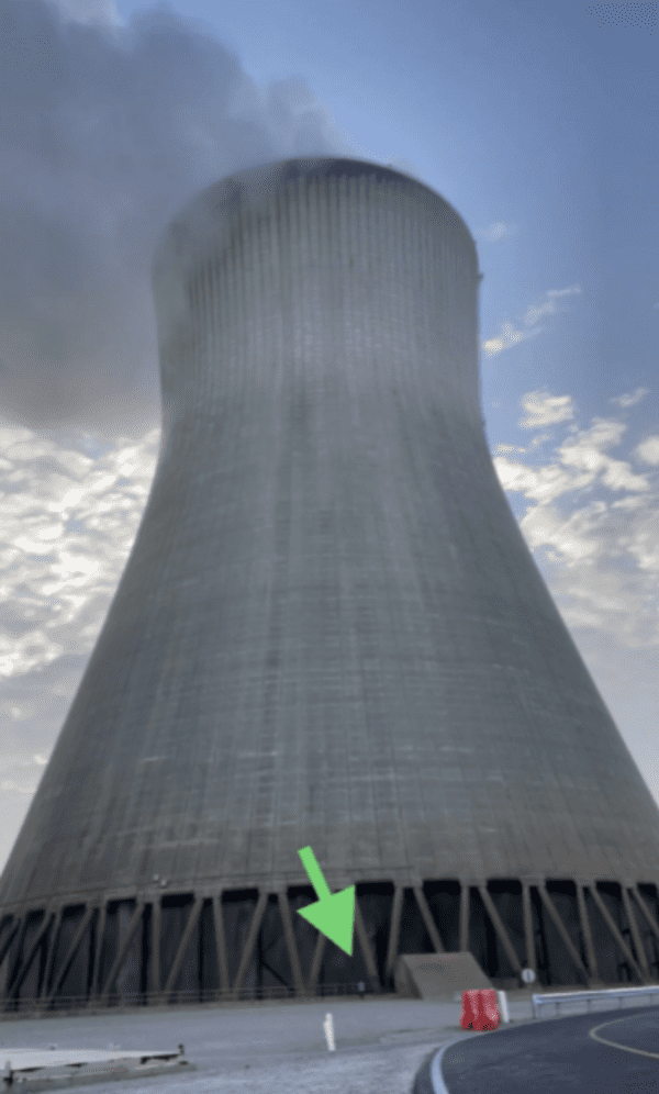 massive things with a human for scale - nuclear cooling tower nexr to persin