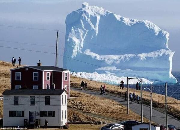 massive things with a human for scale - iceberg passing - ReutersJody Martin
