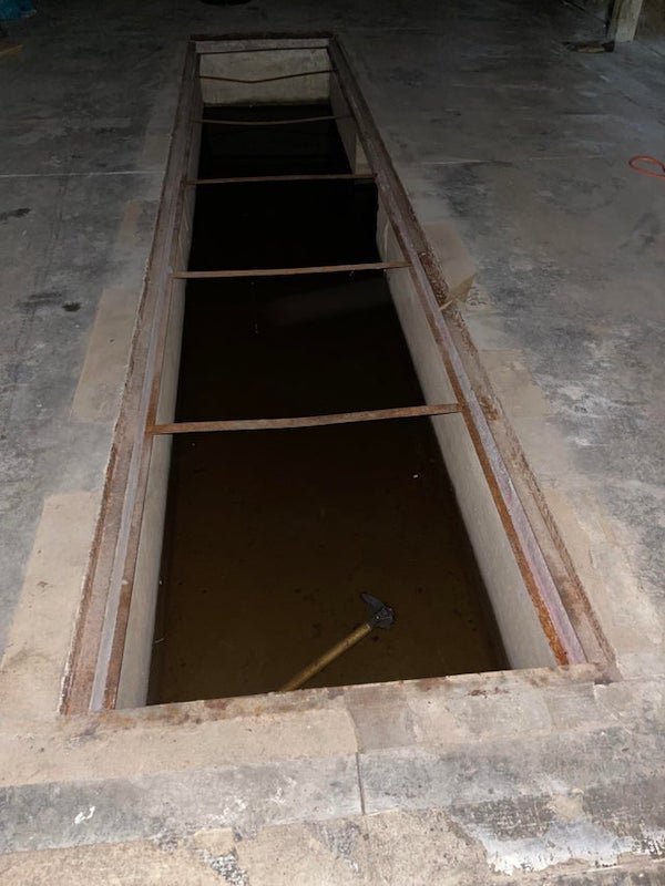 Inside a Pole barn/outbuilding/garage. What is this hole in the foundation used for?

A: It’s an oil change pit.