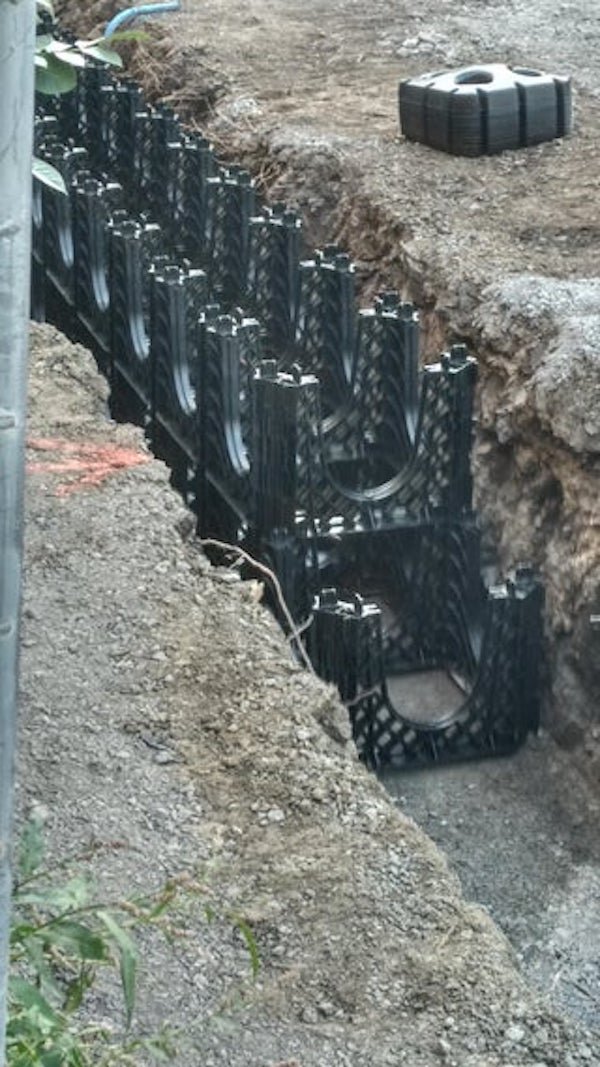 Made of hard plastic, about 1x1x2 feet, they are stackable. Layed down in a trench on a construction site under where will be a sidewalk.

A: I’m pretty sure it’s for storm water management. It may be this exact system.