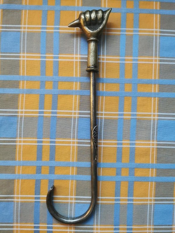 Brass ended hook/pick tool with embossed motif on handle, clearly handmade. What is this thing?

A: It’s a damper hook. It is used to open and close the damper in your chimney.