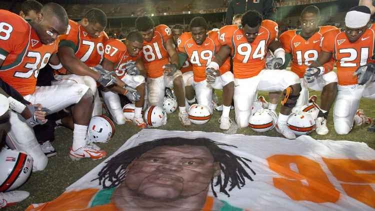 In 2006 Miami Hurricanes players gathered at midfield in prayer for their slain teammate, Bryan Pata, who had been gunned down and killed. 15 years later, his teammate, Rashard Jones (No. 38, at the left), has been charged with his murder.
