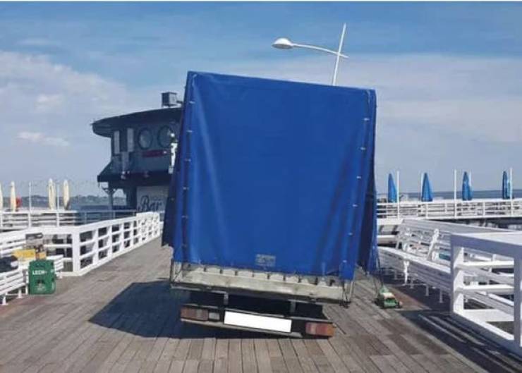 "And this guy who ignored the "No Entry" sign, drove onto a wooden pier, and ended up in this pickle — all because they were too lazy to dolly their cargo in:"