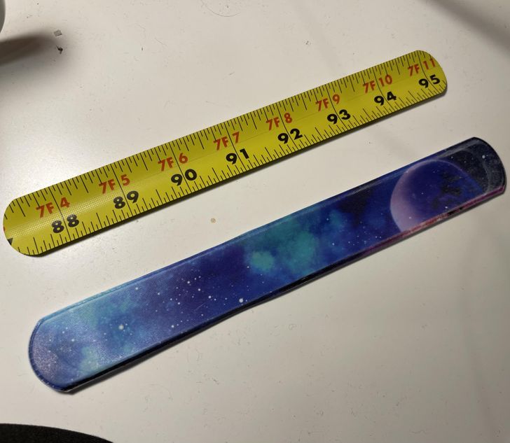 “Unwrapped a slap bracelet to find a recycled piece of measuring tape.”