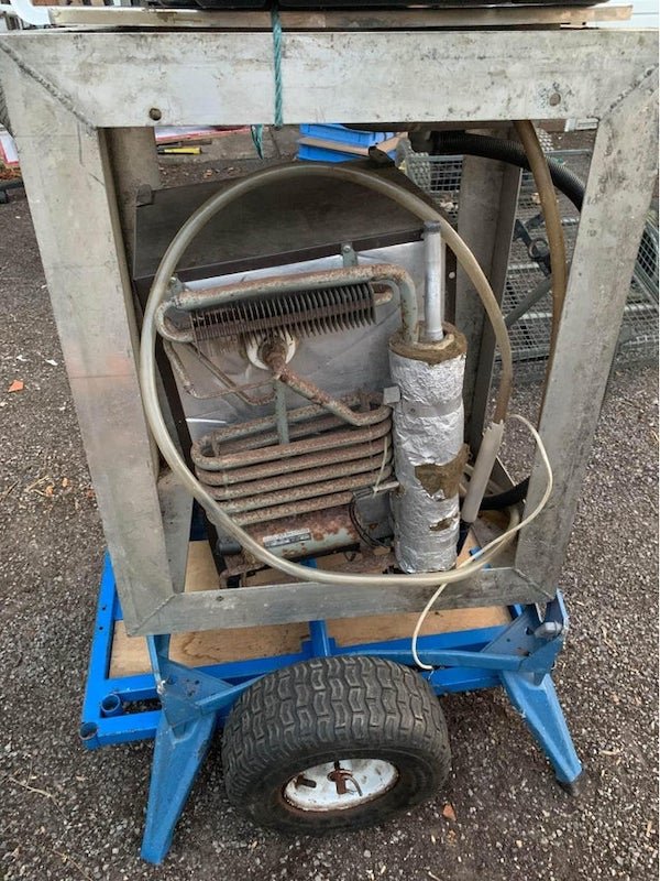 Someone claiming this is a section of Bezos spacecraft that fell in London. It’s clearly not but any idea what it is? He’s asking 700k for it!! What is this thing?

A: It looks like an old mini fridge and some junk.