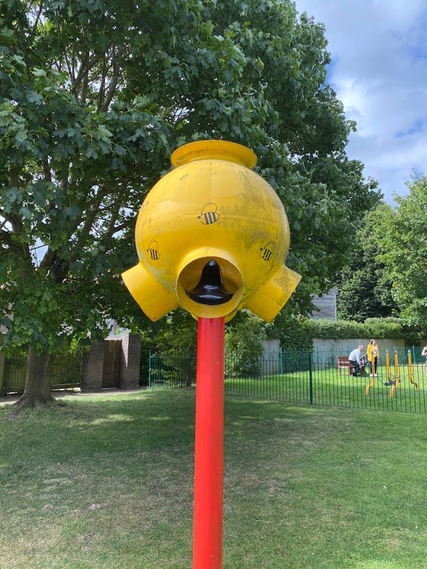 This strange metal thing next to a playground.

A: It is one version of funnel ball. A “game” where you throw the ball in the top, and it comes out one of the holes. Sometimes, the holes have points painted on them.