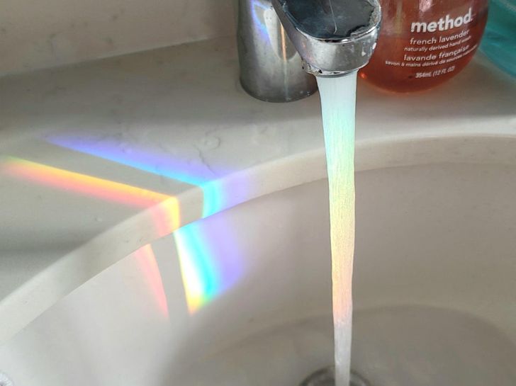 “The refraction rainbow from my glass shower door lined up perfectly with the water stream in my sink.”