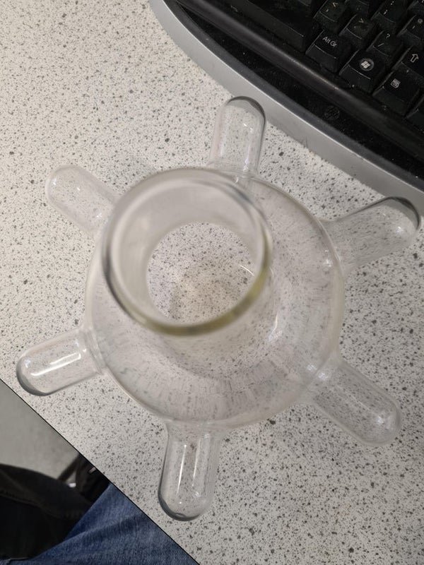 This is a flat bottom flask. It has 6 individual Chambers, appears to be one bit of glass that has been blown out, not multiple parts attached together. Roughly a litre in volume, has been in the science department where I work for over 30 years and no one knows what it is.

A: This is a flat bottom flask. It has 6 individual Chambers, appears to be one bit of glass that has been blown out, not multiple parts attached together. Roughly a litre in volume, has been in the science department where I work for over 30 years and no one knows what it is.