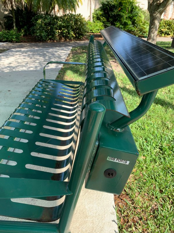 “Solar park bench with USB charging ports.”
