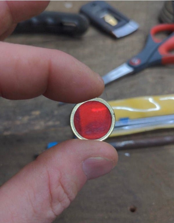 Little red dot, metal border. No idea other than that?

A: Vintage plastic metal bingo chips .