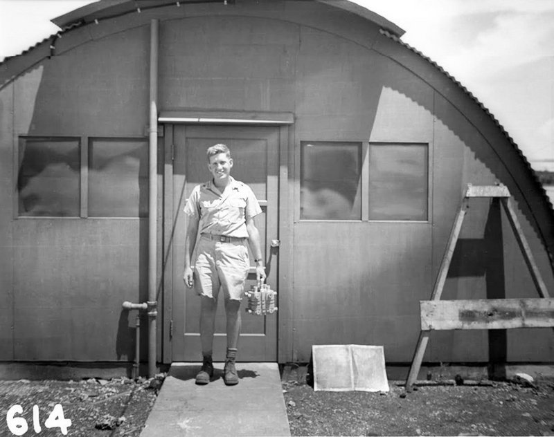 Physicist Harold Agnew smiles while holding the plutonium core of the fat man bomb that would later go on to kill over 70,000 people in Nagasaki, Japan.